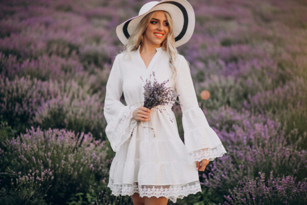 Beautiful woman in white dress in a lavander field
